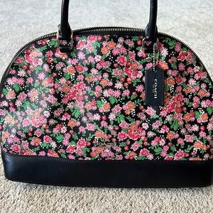 A medium size, floral Coach bag.